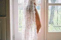 21 a long lace robe of Chantilly lace with long sleeves and a small train over your wedding day lingerie