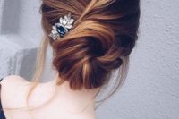 21 a twisted low bun with some locks down and a pretty small hairpiece