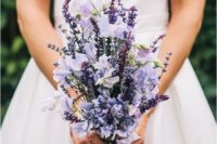 22 a spring wedding bouquet of lavender and lilac flowers and of a vertical shape looks interesting