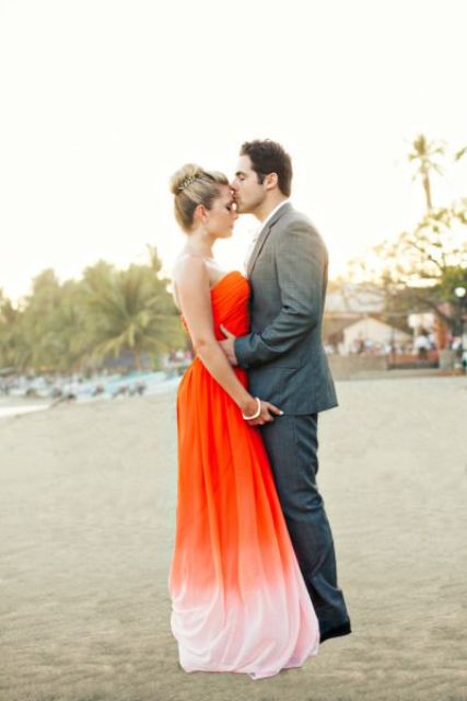 a statement strapless orange wedding dress going to peachy shade on the skirt