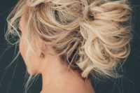 24 a very messy updo with twists and locks down for short hair looks very chic