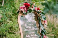 25 a wedding menu decorated with lush magnolia leaves and bold blooms for a refined feel