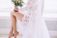 27 a long white lace bridal robe with long sleeves and a train is stunning and looks beautiful