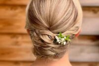 a beautiful and tight twisted low updo with a sleek top and a bit of fresh blooms is a cool and stylish idea for medium and long hair