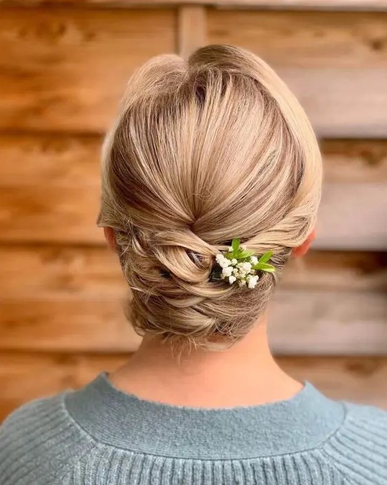 a beautiful and tight twisted low updo with a sleek top and a bit of fresh blooms is a cool and stylish idea for medium and long hair