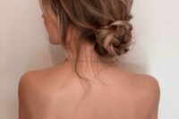 a beautiful knotted low bun with a bit of dimension and locks down is a stylish idea for a wedding