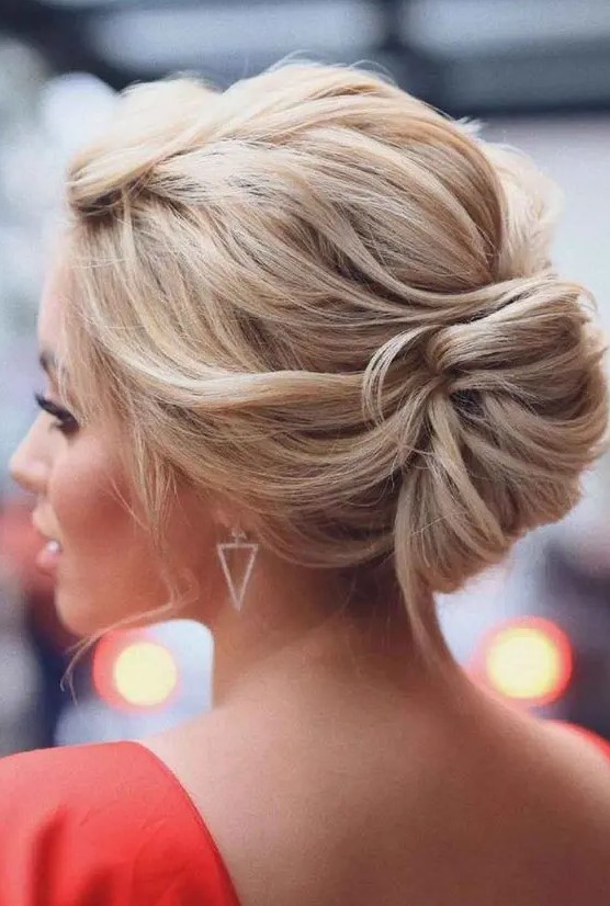 a beautiful twisted low chignon with a twisted volume on top and a bit of locks down is a chic and cool idea