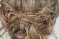 a boho updo with braids and twists and some waves down plus a bump on top is a stylish and cool idea for a bride or a bridesmaid