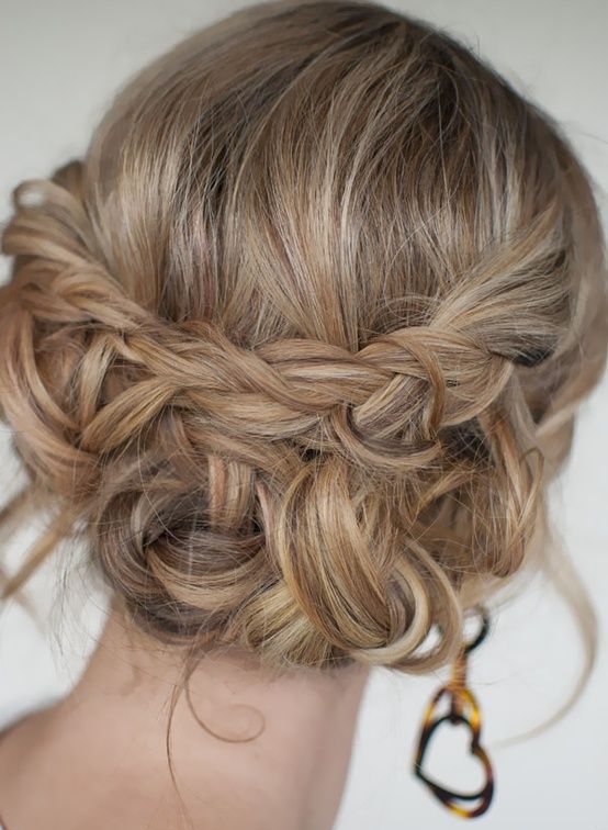 a boho updo with braids and twists and some waves down plus a bump on top is a stylish and cool idea for a bride or a bridesmaid