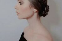 a braided low bun paired with two braided halos is a cool idea of a hairstyle for a wedding, it looks chic