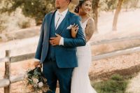 a catchy rustic groom’s look with a navy three-piece suit, a white shirt, a bolo tie and a neutral hat is cool