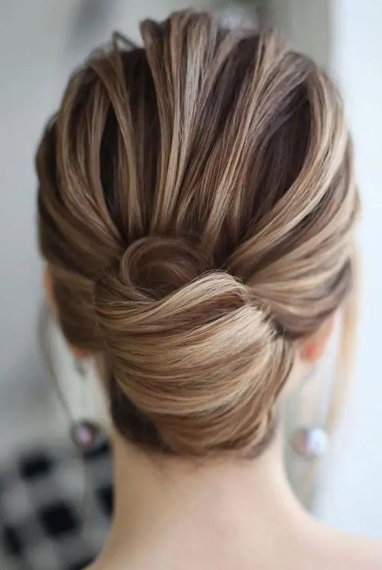 a chic and elegant French twist updo with a voluminous top and an elegant knot will fit medium length hair, too