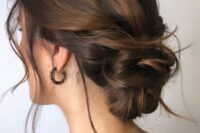 a dark brown woven low updo with caramel balayage and some locks down is a lovely idea for a bride or a bridesmaid
