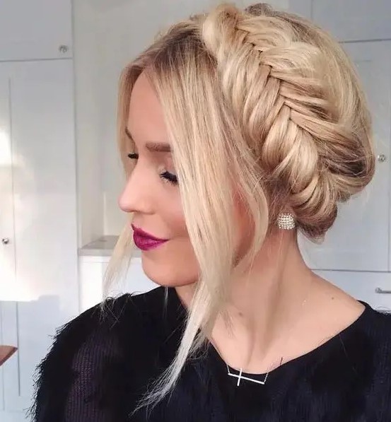 a fishtail braid halo updo with some locks framing the face is great for long hair and for those who love braids