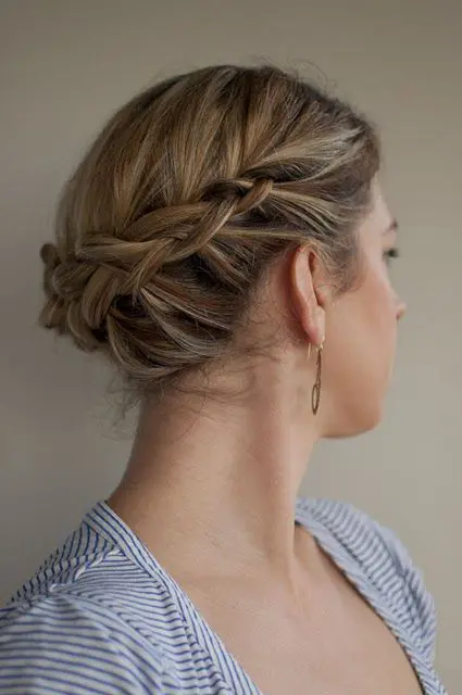 a lovely braided updo with a sleek top is a cool solution for medium length hair, for a boho wedding