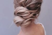 a lovely twisted low updo with a wavy and messy top is a good idea for long hair, you can keep it all up