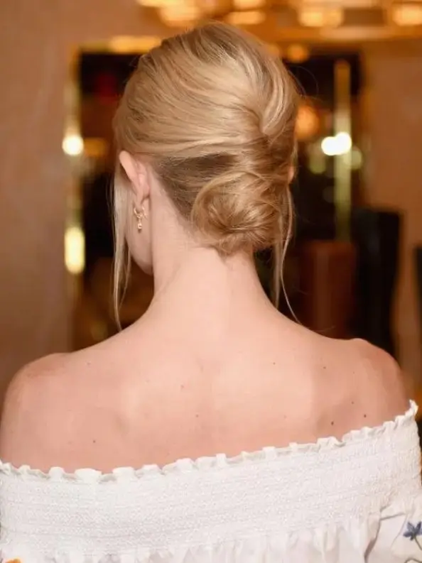 a low French twisted updo with a volume on top and locks down is a stylish idea for a effortlessly chic wedding