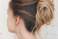 a messy and chic French twist chignon with a messy and layered top and a messy low bun