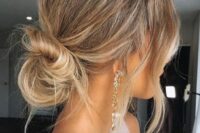 a messy twisted low bun with a volume on top and textured hair and waves down is a good idea for medium length hair