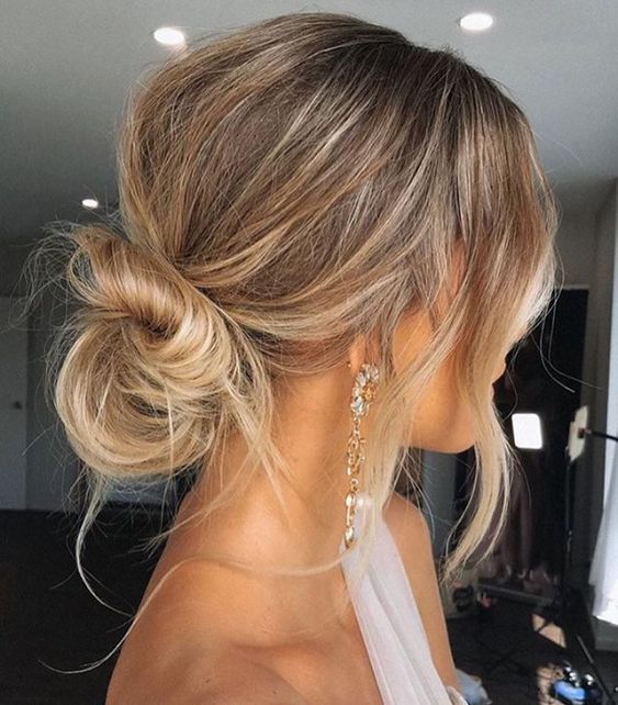 a messy twisted low bun with a volume on top and textured hair and waves down is a good idea for medium length hair