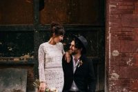 a relaxed groom’s look with a white shirt, blue jeans, black loafers, a black blazer and a hat is a cool idea for a boho wedding