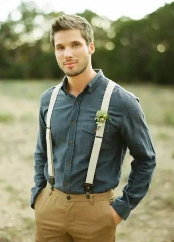 a rustic groom's look with mustard pants, a dark chambray shirt and neutral suspenders