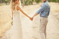 a rustic groom’s look with neutral pants, a blue shirt, neutral suspenders and brown boots