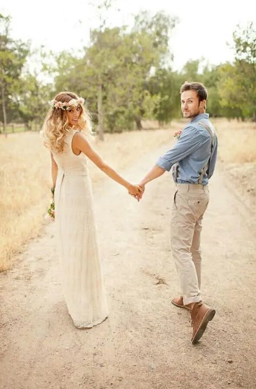 a rustic groom's look with neutral pants, a blue shirt, neutral suspenders and brown boots
