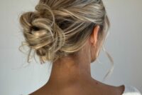 a soft, messy and loose updo with a sleek top and twisted hair plus some waves is a lovely idea for a wedding