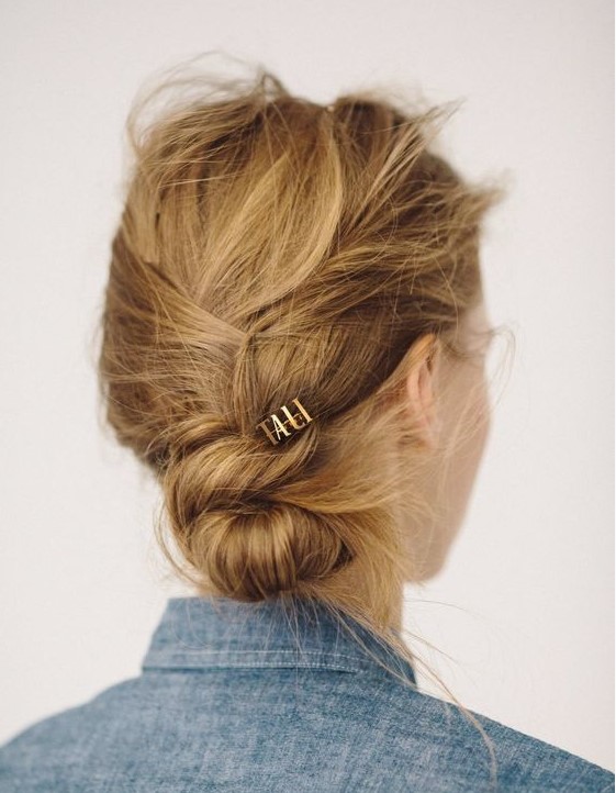 a super messy and textured twisted low bun is a fast solution to make on the go