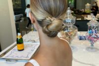 a tight twisted low bun with a sleek top is an elegant and refined idea for both a bride and a bridesmaid