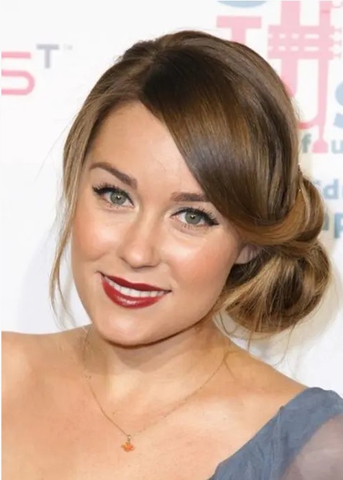 a twisted side bun with a voluminous top with bangs is an elegant and timeless idea to rock