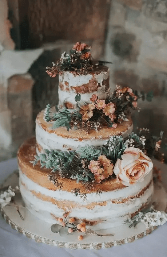 a yummy naked wedding cake with succulents and blush blooms and berries is a lovely idea for a spring summer rustic wedding