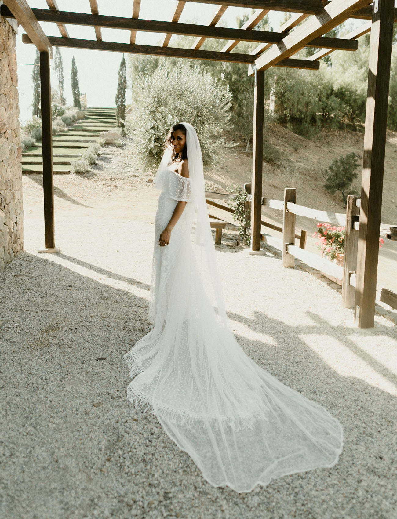 The bride was wearing a stunning off the shoulder polka dot wedding dress and a matching veil