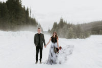01 This gorgeous wedding shoot took place in the snowy mountains, and the contrast between dark colors and snow is striking