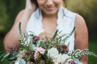 The bride was carrying a gorgeous and super lush wedding bouquet and lots of greenery