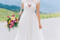 02 The bride was wearing a retro-inspired tea-length wedding dress with colorful floral embroidery, an illusion neckline and T-strap shoes