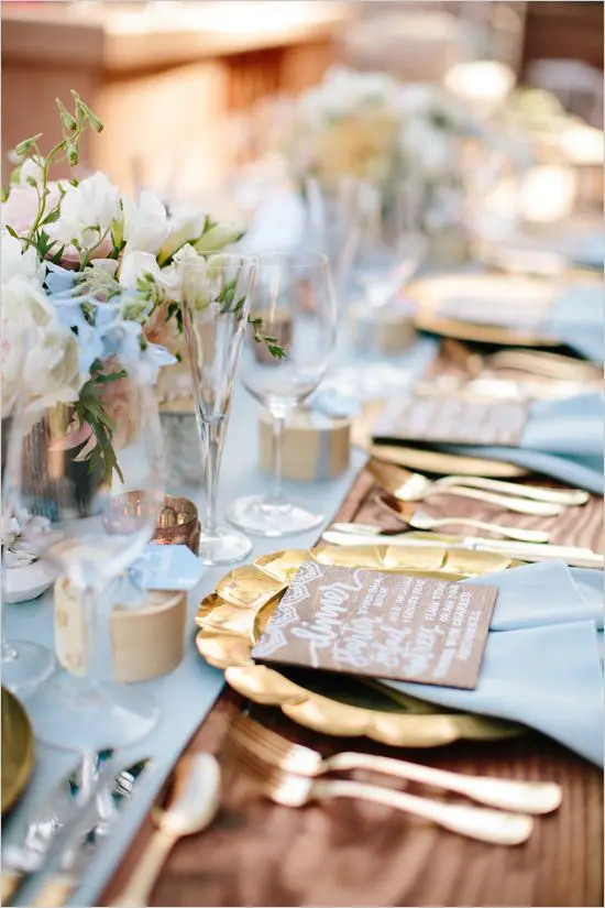 birds' egg blue textiles and blooms combined with gold chargers, cutlery and vases