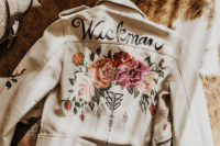 03 She covered up with a creamy leather jacket with hand-painted flowers
