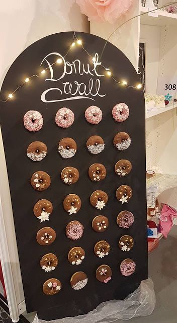a chalkboard donut wall topped with LED lights is a cute idea