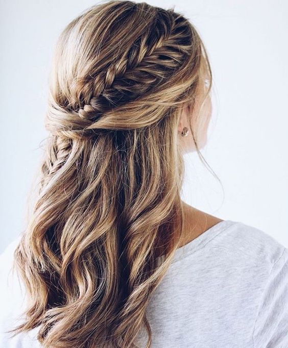 a chic half updo with waves, twists and a fishtail braid going down
