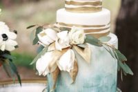 03 a fine art wedding cake with watercolor blues and gold stripes plues white blooms and gilded leaves