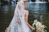 03 a long veil with a faux flower halo on top and pastel-colored faux blooms all over the veil
