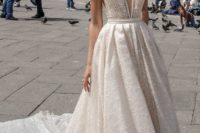 03 a wide strap plunging neckline wedding ballgown with heavy embellishments and a train by Julie Vino