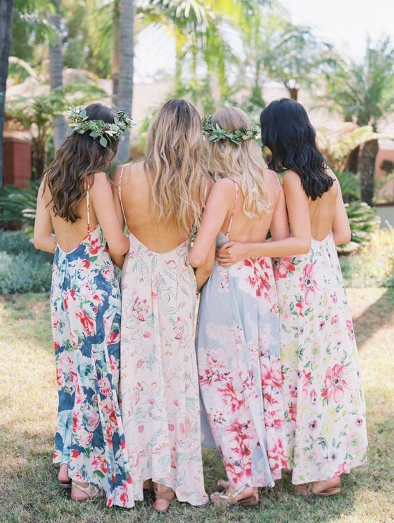mismatched spaghetti strap dresses with open backs in various pastel shades and with different floral prints