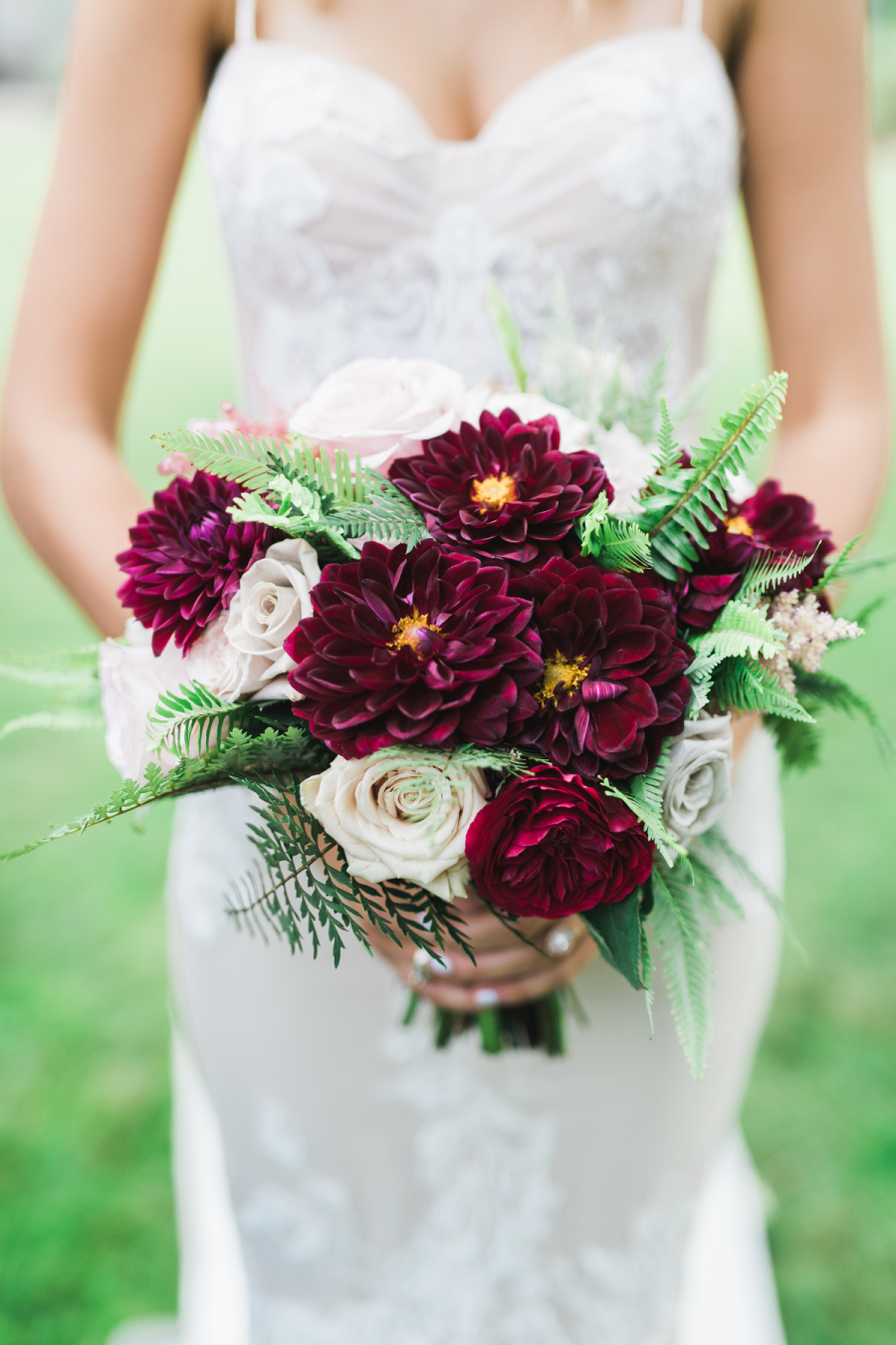 Her bouquet was done with creamy and deep burgundy blooms to highlight the jewel color scheme