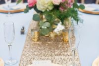 04 a gold sequin table runner, gold vases and candle holders, blue fabrics for a chic look