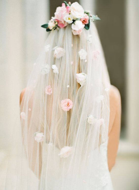 a veil with pearls and faux florals on the veil and its top looks veyr spring-like
