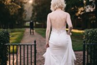 05 The bride was wearing a jaw-dropping wedding dress with spaghetti straps, a lace applique bodice with an open back and buttons on the back