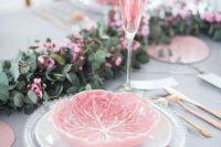 05 a chic tablescape with a grey tablecloth, a eucalyptus and pink bloom table runner, pink napkins and plates
